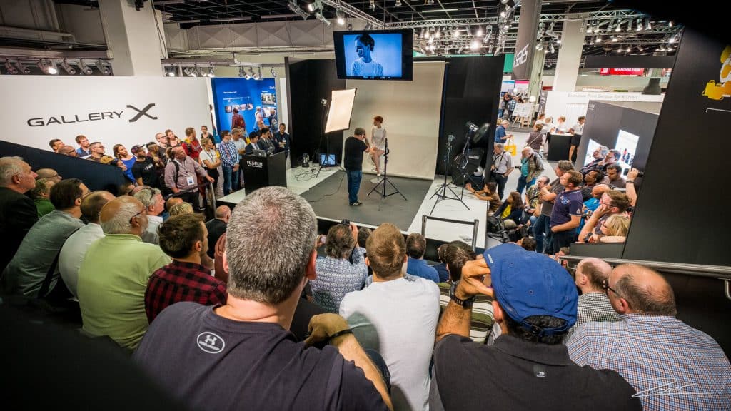 Zach Arias demonstrating lighting techniques in a overflowing Fujifilm theatre.