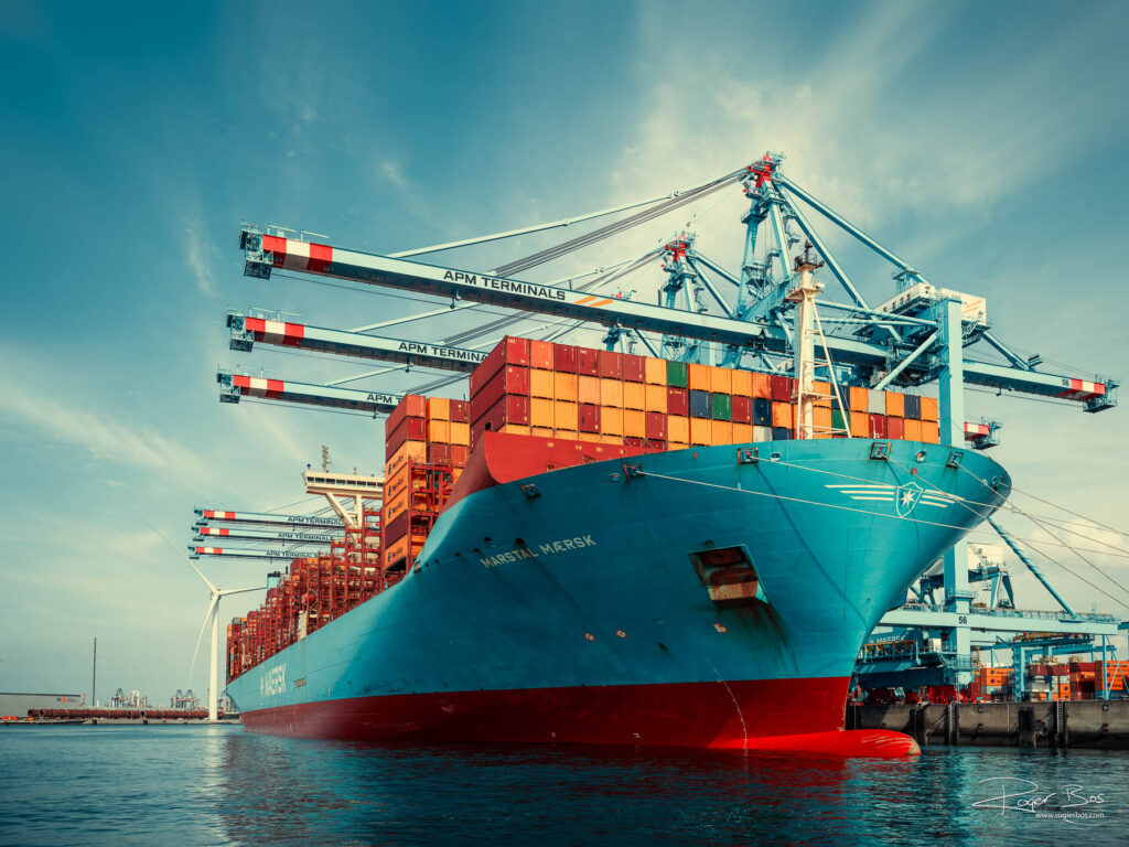 Port shot of the container ship Marstal Maersk (399 m length, Denmark flag) loading at APM Terminals in the port of Rotterdam, industrial maritime sector photography