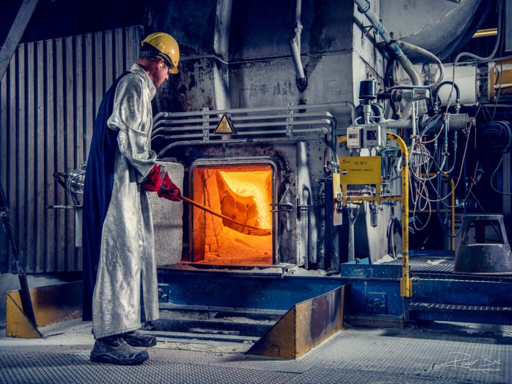 Industriële fotograaf legt operator vast die oven bedient bij productie van hittebestendige materialen in Rotterdam Botlek.